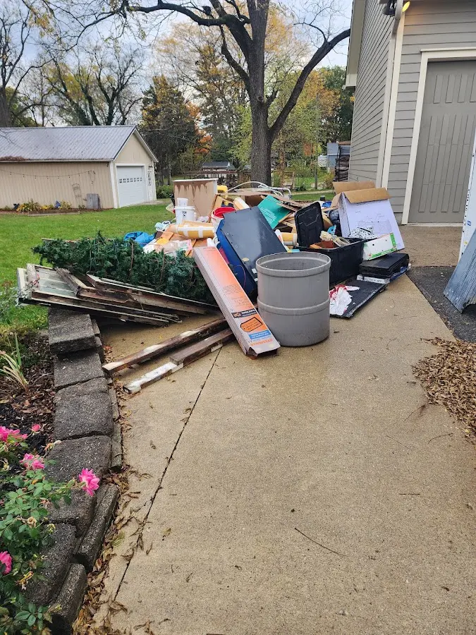 Dumpster being loaded with debris for Estate Cleanout Dumpster Rental in Mayfair